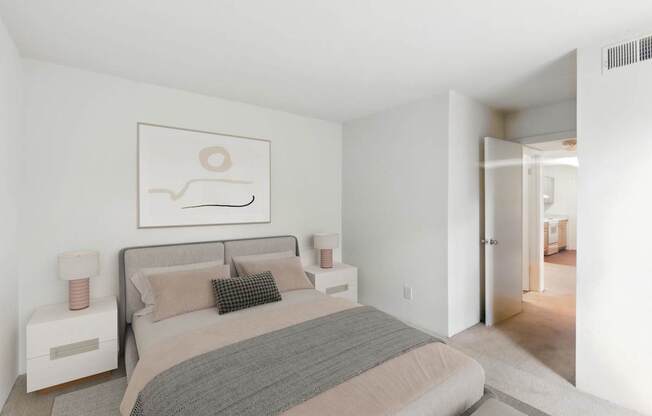 A bedroom with a bed, nightstands, and a painting on the wall.