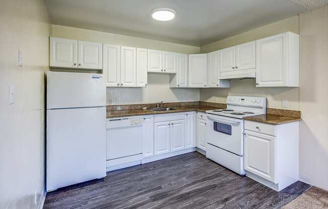 a kitchen with white cabinets and white appliances at Terrace View Apartments, California, 94015