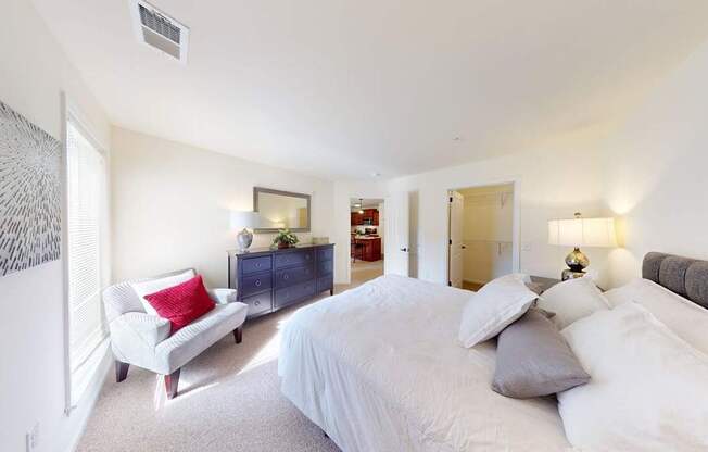 A bedroom with a large bed and a couch.