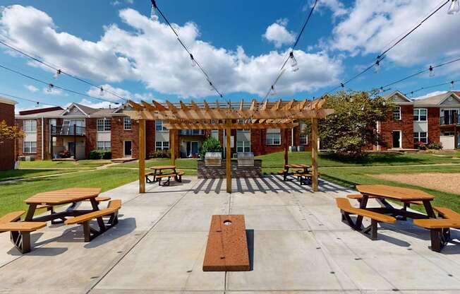 a picnic area with benches and a pergola