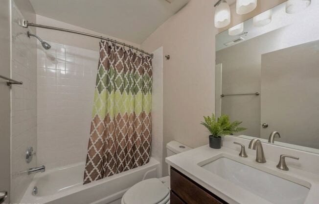 Bathroom with vanity storage and a full tub at Carriage House Lofts, Chicago