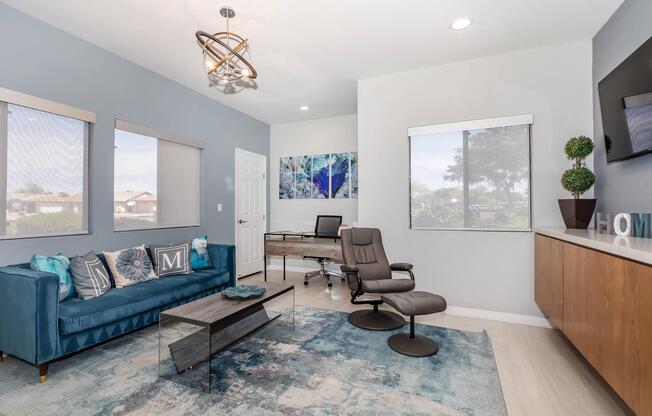 a living room filled with furniture and a large window