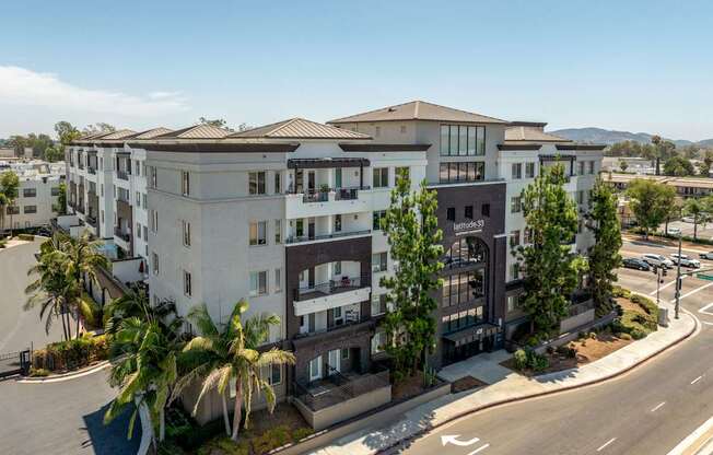 A modern apartment complex with a clear blue sky above.