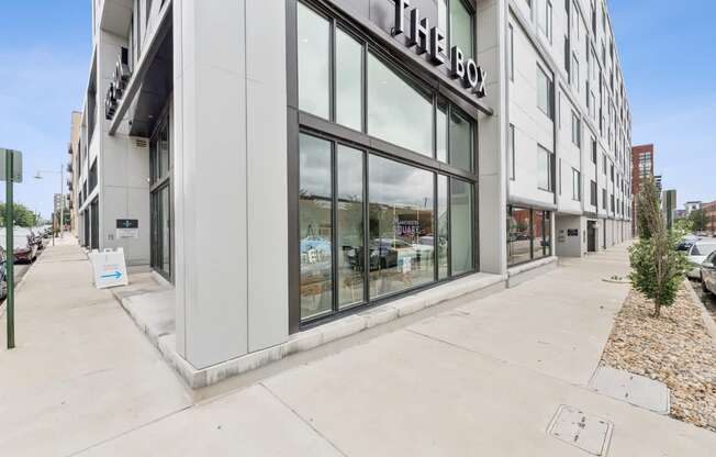 The box storefront is white and has a black awning.