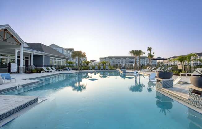 a large swimming pool with a building in the background