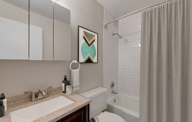 a bathroom with a shower and a sink and a toilet