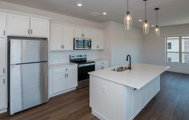a kitchen with white cabinets and a white counter top at The Crossings at Windsong, Prescott Valley, 86314