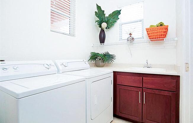 A white washing machine and dryer in a laundry room.
