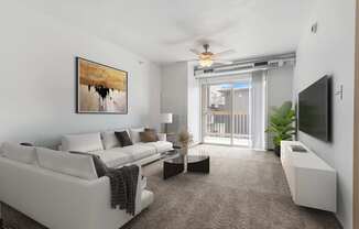 A living room with a white couch and a painting on the wall.