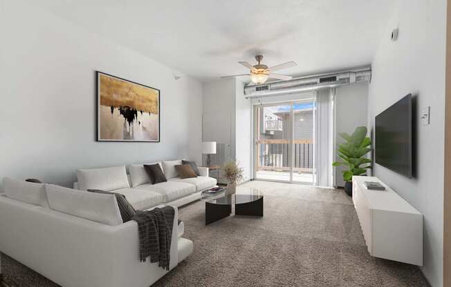 A living room with a white couch and a painting on the wall.
