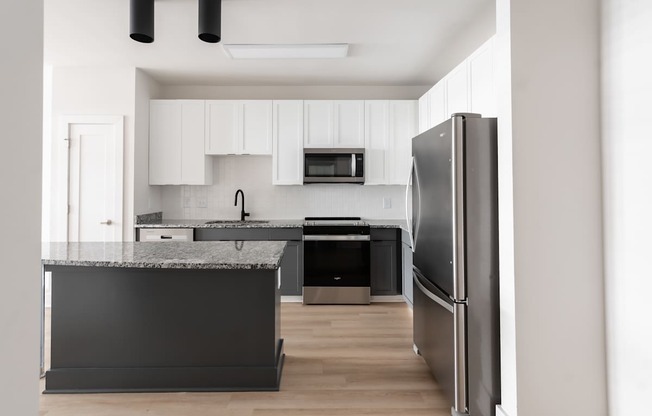A modern kitchen with a refrigerator on the right.