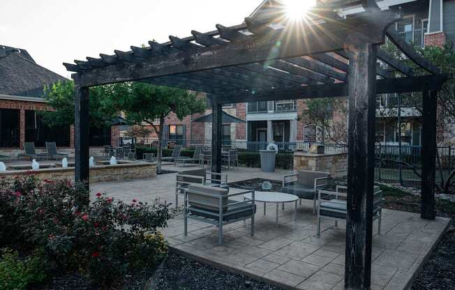 a patio with tables and chairs and a pergola