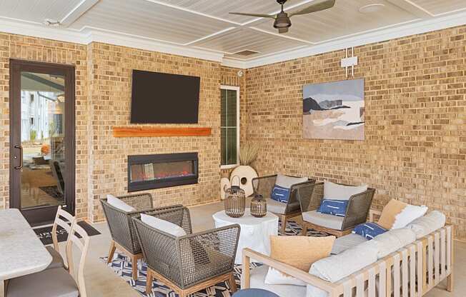 A living room with a fireplace and a flat screen TV mounted on the wall.