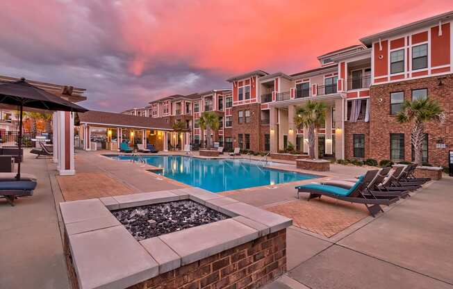 our apartments have a large swimming pool with lounge chairs and umbrellas at Nexus at Sandhill, Columbia, SC