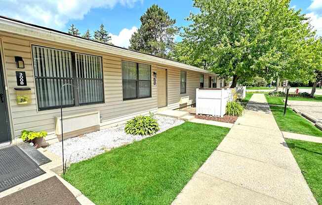 A small building with a white fence in front of it.