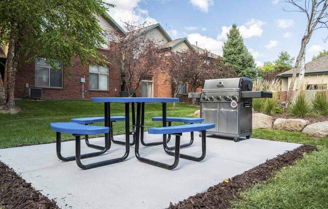Picnic table with outdoor grill at Southwind Villas in southwest Omaha in La Vista, NE, 68128