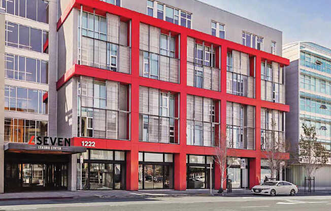 A building with red accents and L Seven logo at L Seven Apartments in San Francisco, CA