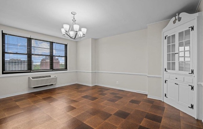 an empty living room with a window and a white door