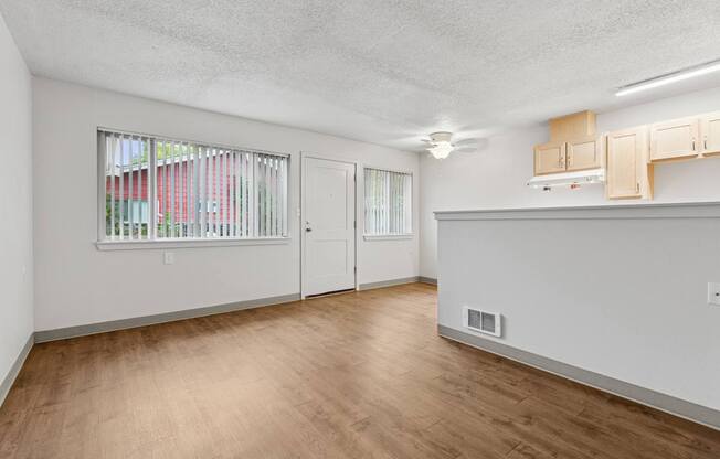 A room with a window and wooden floors.
