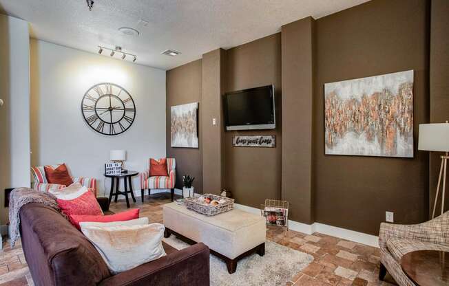 a living room with a large clock on the wall At Metropolitan Apartments in Little Rock, AR