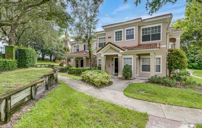 A large house with a driveway and a fence.
