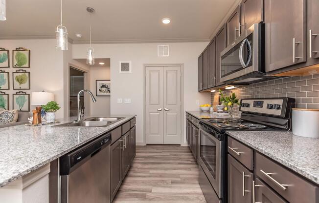 a modern kitchen with stainless steel appliances and wooden cabinets