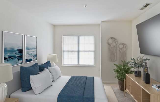 a bedroom with a large bed and a tv