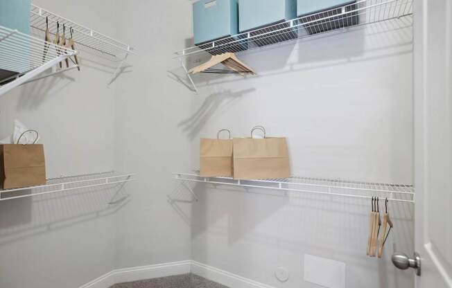 A kitchen pantry with a white wall and a door.