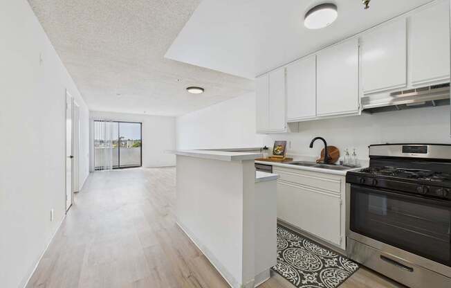 A kitchen with a white island and stove top oven.