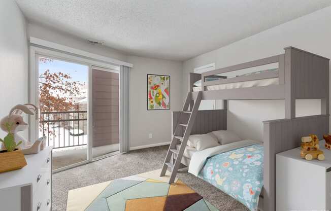 a bedroom with a bunk bed and a sliding glass door at Eastwood Crossings, Kansas City, MO, 64129