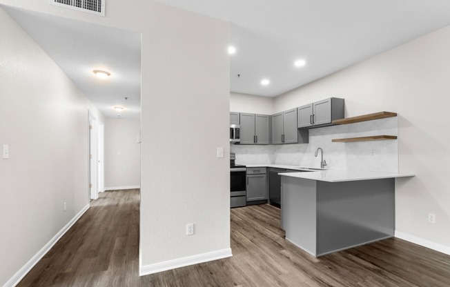 the living room and kitchen of a new home with an open floor plan at Switchback on Platte Apartments, Colorado