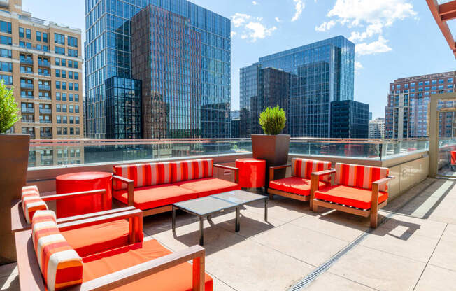 a rooftop patio with a view of the city and skyscrapers