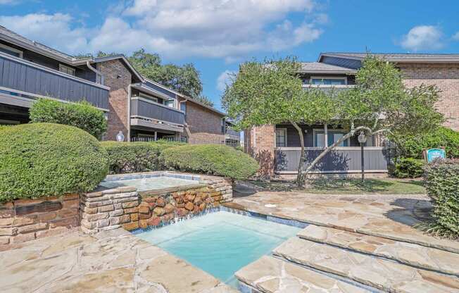 3ft section of the pool with a walkway and a fountain feature above at The Pearl apartments in Shreveport, LA