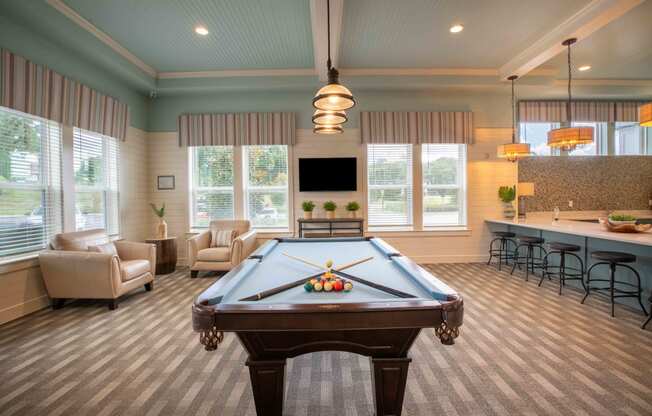 a game room with a pool table and a bar