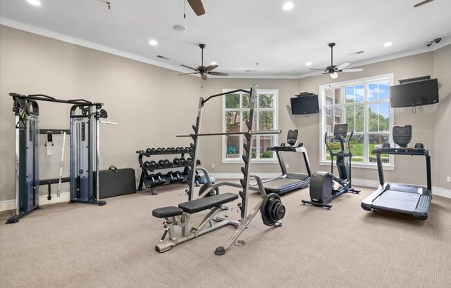 A spacious home gym with a variety of exercise equipment. at Stonepost Lakeside Apartment Homes, Olathe, 66062