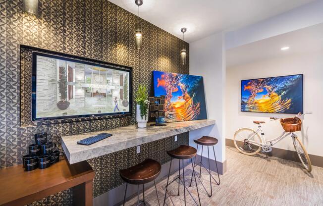 Work lounge with bar seating and vibrant artwork for casual productivity.