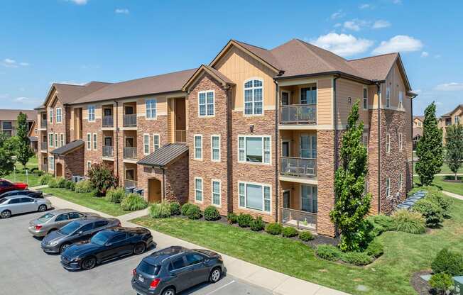 an apartment building with cars parked in front of it