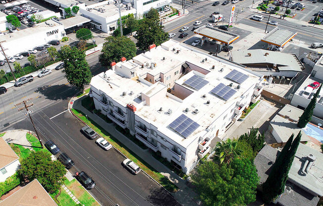 Aerial drone photo of Magnolia Terrace showing solar panels and energy-efficient white roof.