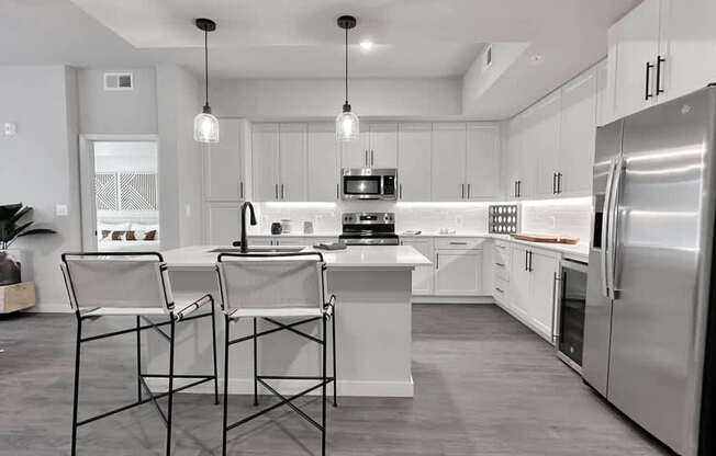 Fully-equipped kitchens with stainless steel appliances, wine coolers and 42" white cabinetry