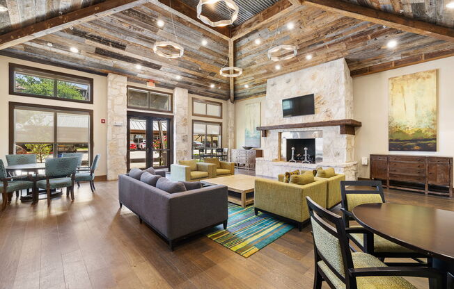 a living room with couches and chairs and a fireplace at Lakeline East Apartments, Texas, 78613