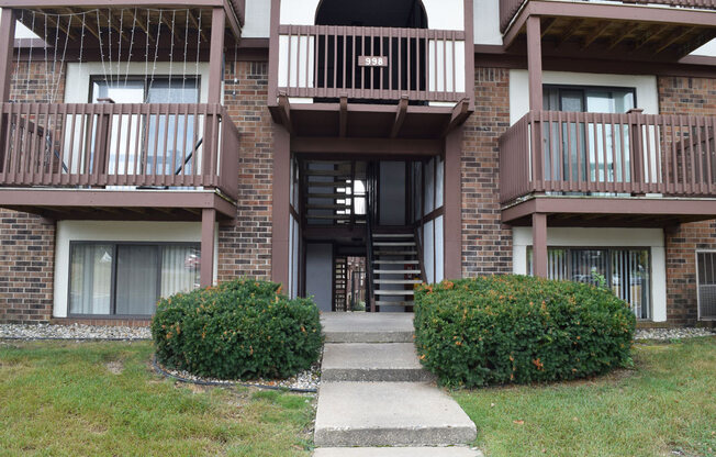 the walkway up to the entrance of a brick apartment building at Seville Apartments, Michigan