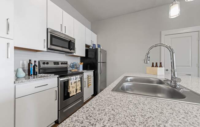 a kitchen with granite counter tops and a sink