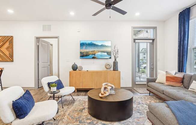 a living room with furniture and a ceiling fan