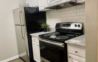 Upgraded kitchen with a stove and a refrigerator at The Pointe at Irving Park, Greensboro, NC, 27408