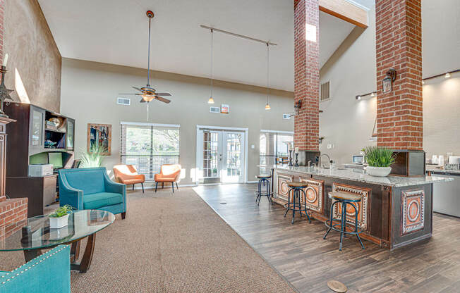 A modern kitchen with a bar and seating area.