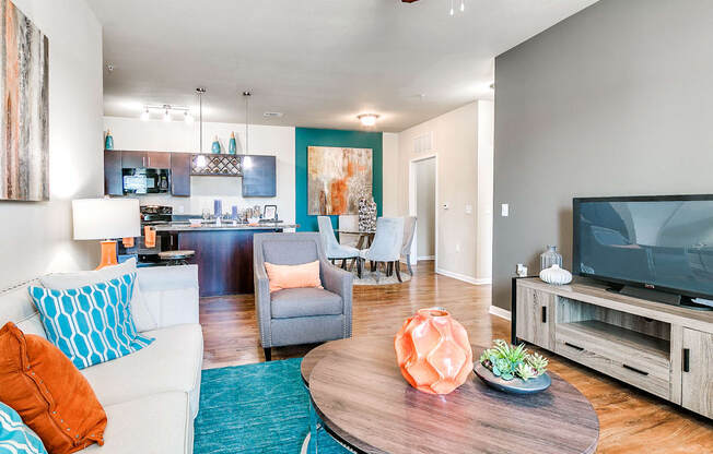 a living room with a couch and a chair in front of a tv