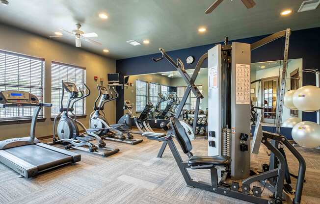 gym with cardio equipment at the whispering winds apartments in pearland, tx