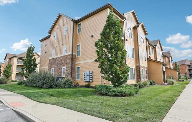 our apartments are located on the corner of a street with grass