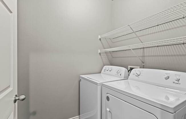 A white washing machine and dryer in a laundry room.