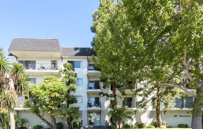 a large white building with trees in front of it